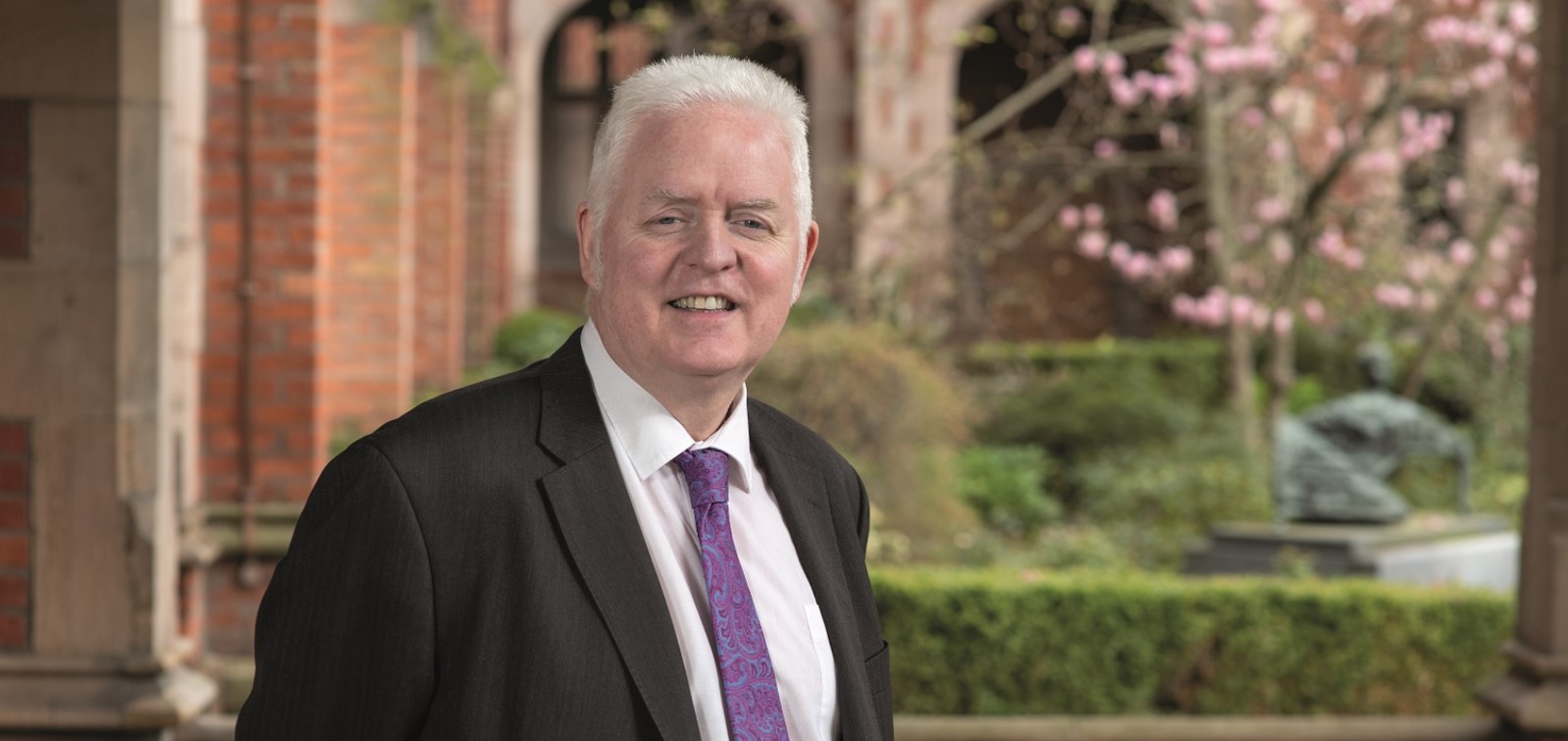 Data Navigator launched Professor Mark Lawler in jacket and tie in quad at Queen's University Belfast