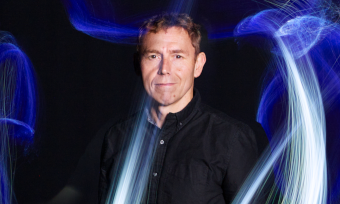 man standing in waves of light