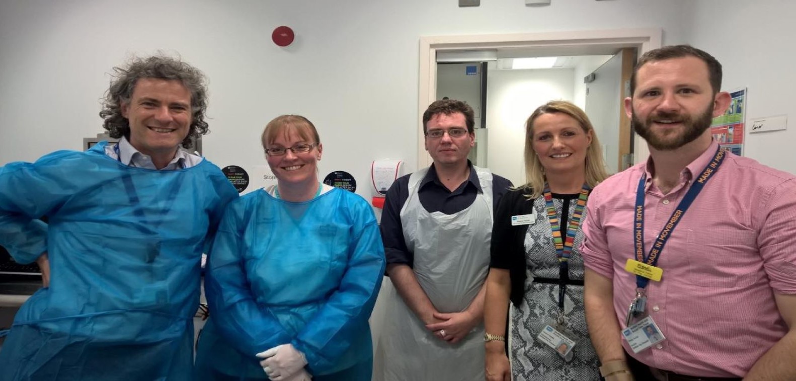 Combination radiotherapy trial Five Queen's researchers - 3 males, 2 feamles, in laboratory