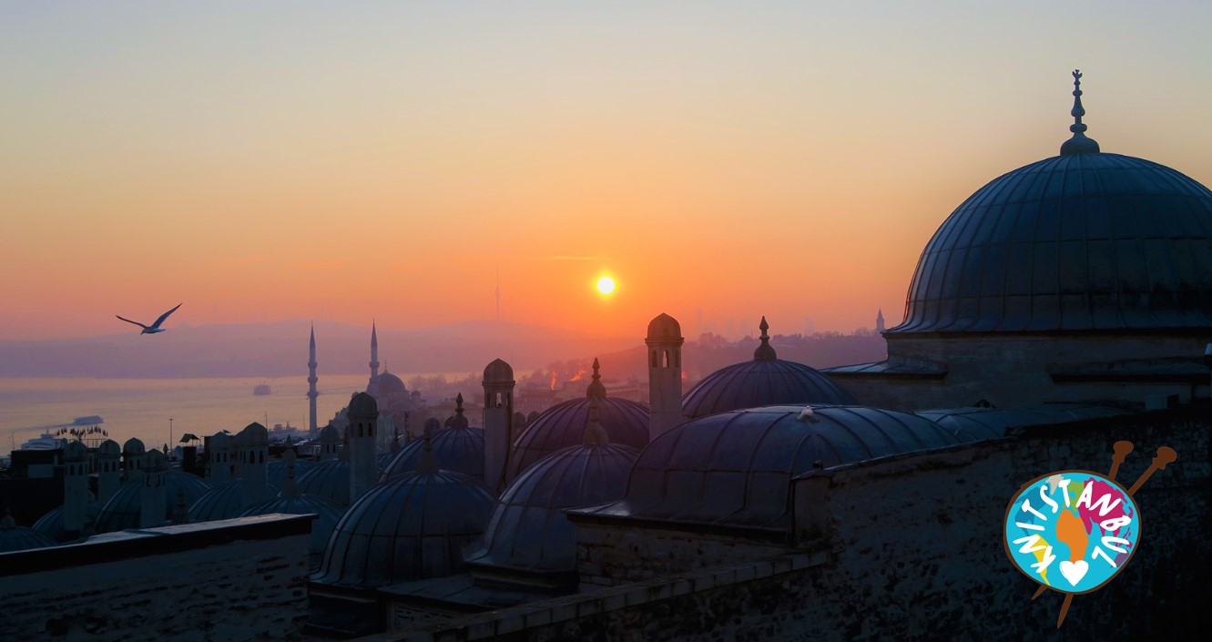 Knitstanbul social enterprise Sunset sky over Istanbul with Knitstanbul logo in corner, showing word written around simplified globe (like a multicoloured ball of wool), with two knitting needles running through it
