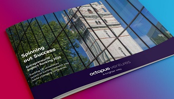 Glossy document with reflection of university building in window against blue sky